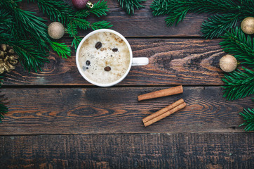 Coffee with cinnamonon christmas decoration. Top view