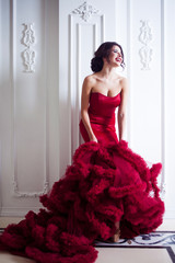 Beauty Brunette model woman in evening red dress. Beautiful fashion luxury makeup and hairstyle, full length