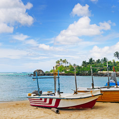 Naklejka na ściany i meble fishing boat on the sandy shore against a background the ocean a