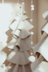 large gray fir-tree made of felt and wool. Christmas composition with decoration on white background. Scandinavian style. Monochrome