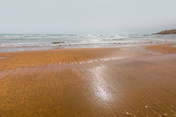 Fototapeta na wymiar Gentle waves breaking over an idyllic beach
