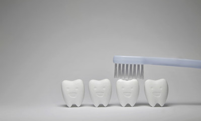Fototapeta na wymiar Blue Toothbrush on Tooth model in happy emotion and blue, if brush the teeth, teeth will good healthy 