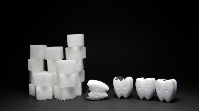 Heap of a lot of cubes sugar and Decayed tooth 