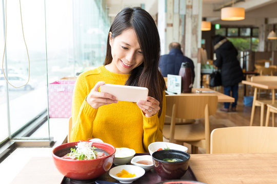 Woman taking photo before having lunch