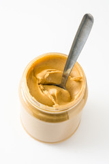 Creamy peanut butter and spoon isolated on white background

