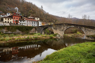 Obraz premium Roman bridge of Puente de Arco. Situated in the village of Puente de Arco, 2 Kilometres from Pola de Laviana, Asturias, Spain. It crosses the Nalon river and its construction date is uncertain.