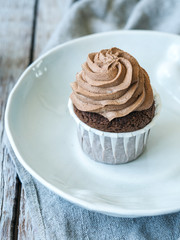 Homemade cupcake on wooden background