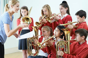 Group Of Students Playing In School Orchestra Together