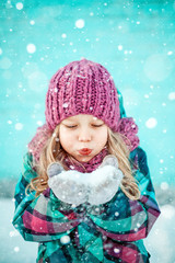 Winter portrait of a pretty little girl.