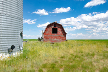 Weathered Old Red Barn western canada with grain bin