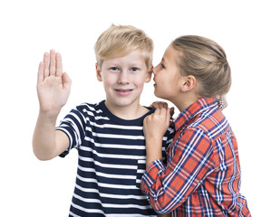 Caucasian boy pushing an imaginary button and girl whispering ear, white background