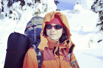 Winter hiking in the mountains on snowshoes with a backpack and