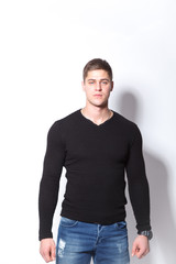 Confident and stylish. Cheerful young man  looking at camera while standing against white background