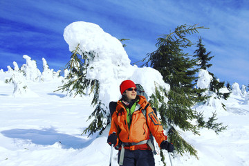 Winter hiking in the mountains on snowshoes with a backpack and