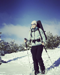 Fototapeta na wymiar Winter hiking in the mountains on snowshoes with a backpack and