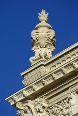 Fototapeta na wymiar Corniches et sculptures des toits du Louvre à Paris, France