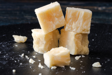 White Cheddar Cheese Cubes on a Black Slate - obrazy, fototapety, plakaty