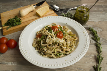 Italian vegetarian pasta with tomatoes, cheese and arugula