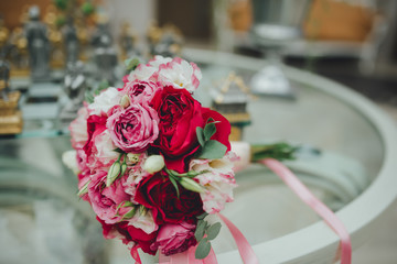 beautiful wedding bouquet of red roses on the table