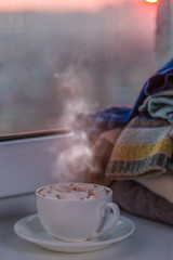 Hot chocolate with marshmallow by the window