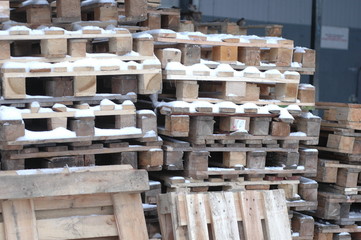 Several pallets near the store in winter.