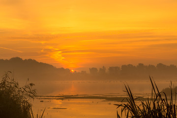 Orange sunrise above the lake