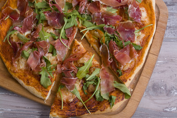 Homemade Italian pizza with tomato sauce, ham and cheese