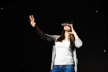 a beautiful girl wearing a virtual reality device, standing on t