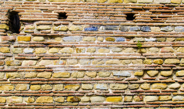 Wall made of stone or brick in the archaeological ruins of the ancient Roman town Velia, Campania. Italy