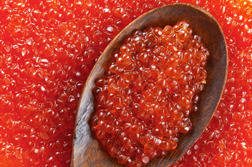 Red caviar on a wooden spoon