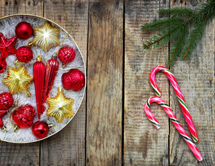 Round box with red and gold Christmas decorations. New Year and Xmas card background. Copy space. Selective focus.