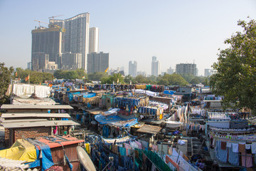Fototapeta na wymiar india mumbai slum people and children working and living laundry, plasitic 