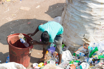 india mumbai slum people and children working and living laundry, plasitic
