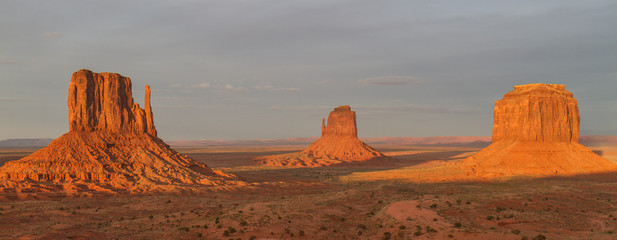 Sunrise on the Mittens - The sun rises and shines on the most famous and iconic monuments in Monument Valley - the West Mitten and the East Mitten. Also know as the Left Mitten and the Right Mitten.
