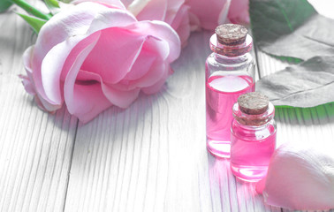 organic cosmetic with rose oil on wooden background close up