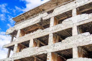 War damaged building against cloudy sky