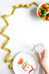 concept slimming diet fresh vegetables on white background top view