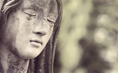 Statue of Virgin Mary in tears (sadness, regret, fear, religion,