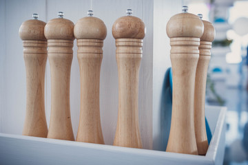 Row of wooden pepper mills