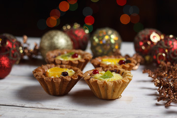Homemade desserts with fruits for the new year. Desserts for the holidays. Side view. Against dereeva and trees. Beautiful background.