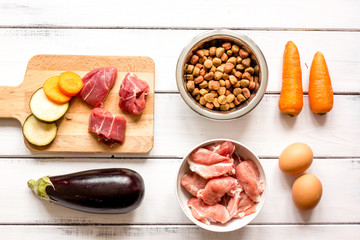 ingredients for pet food holistic top view on wooden background