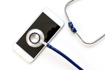 Fototapeta na wymiar diagnostic of gadgets on white background with stethoscope