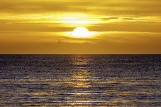 New Day At Sea. The Sun Rising Over A Beautiful Calm Sea.