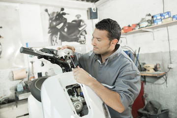 man assembling scooter © auremar