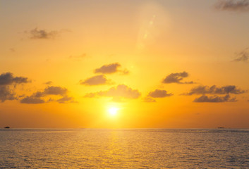 Naklejka na ściany i meble Sunset on sea in Maldives