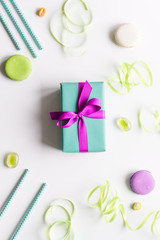 Gift box with colorful party items white background top view