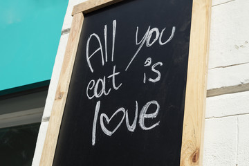 Restaurant's chalkboard with the written sentence: 