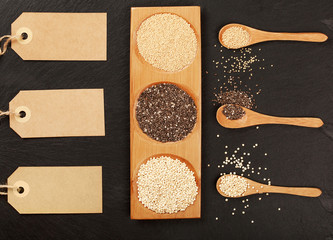 Quinoa, chia and amarantus seeds in wooden spoons