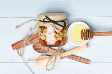 Jar nuts with honey spoons