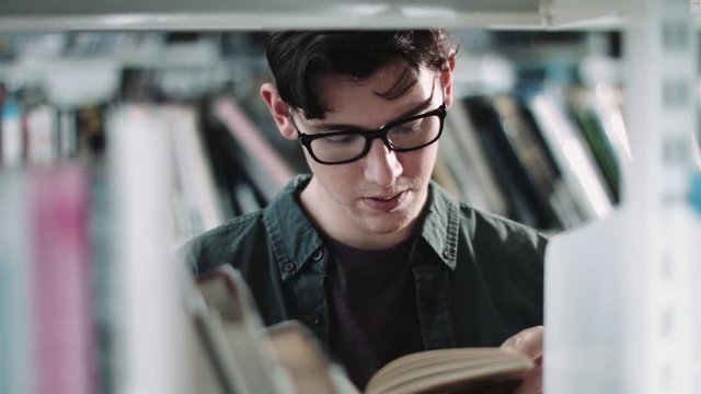 Student reading in a library
